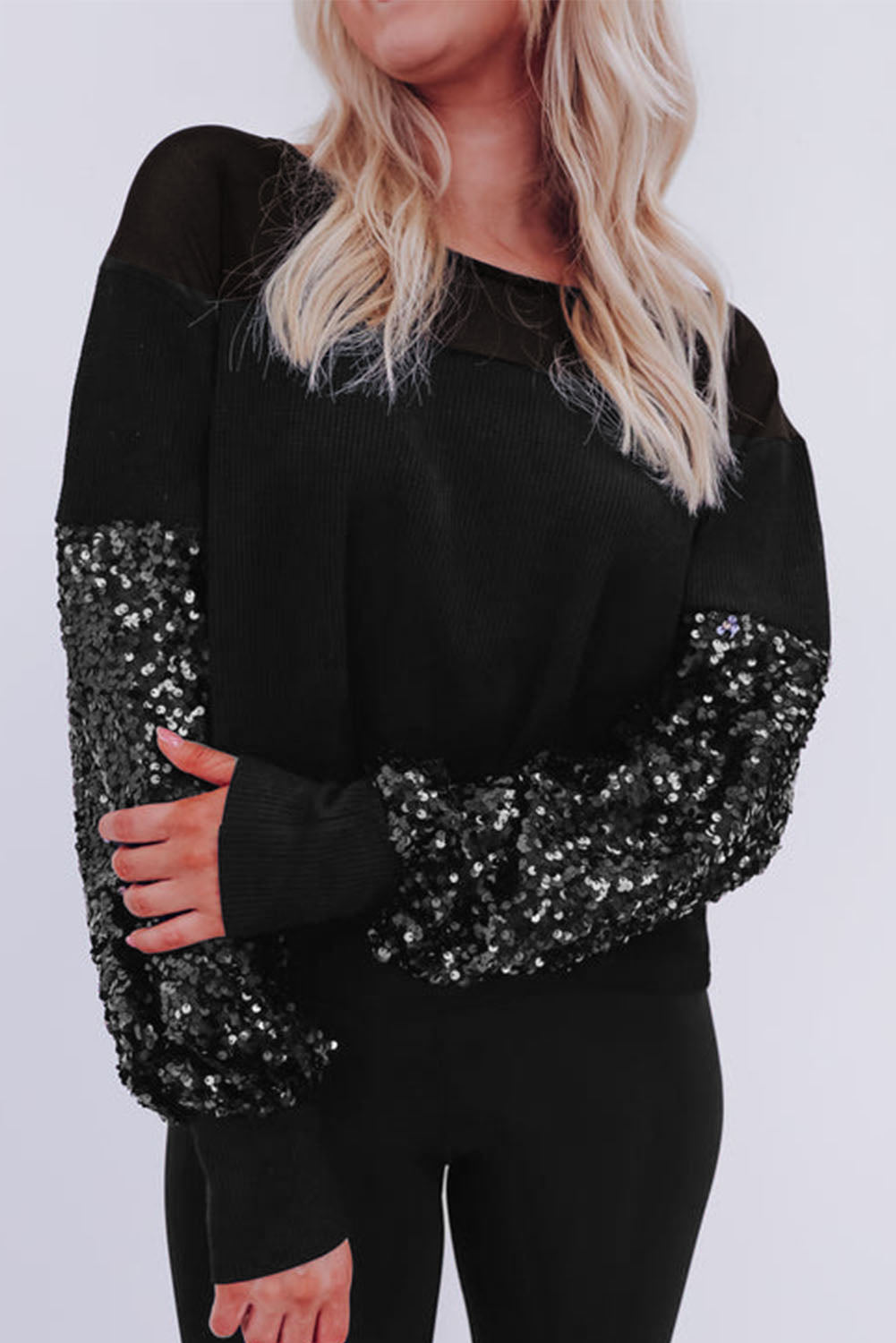 Zwarte blouse met patchwork en lantaarnmouwen met pailletten