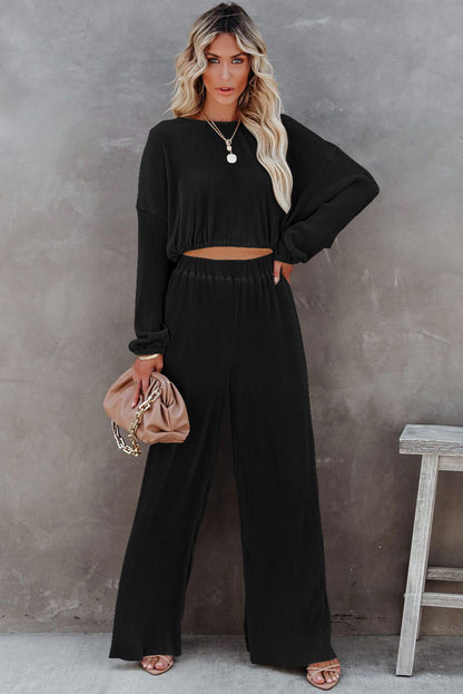Zwarte cropped trui met koord en broek met wijde pijpen