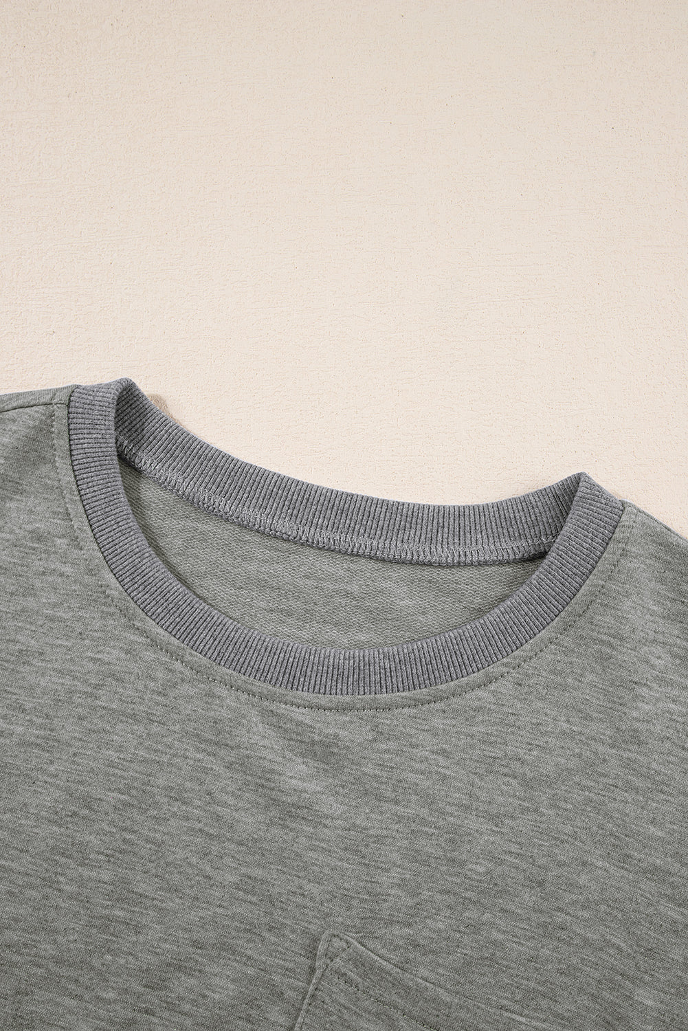 Lichtgrijs los T-shirt met zichtbare naad en borstzak