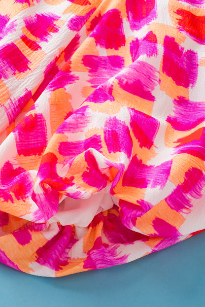 Roze blouse met abstracte print en knoopsluiting op de rug met ruches en hoge hals