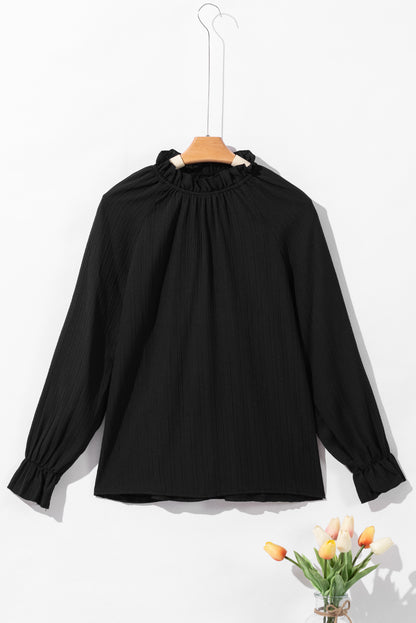 Zwarte blouse met ruches en rimpelige bubbelmouw