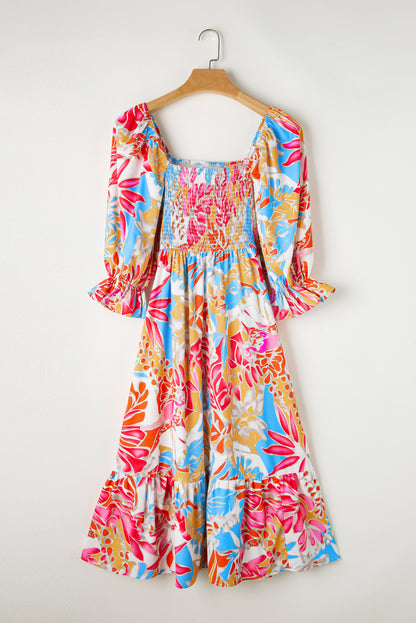 Rozerode maxi-jurk met gesmokt lijfje en pofmouwen met tropische print