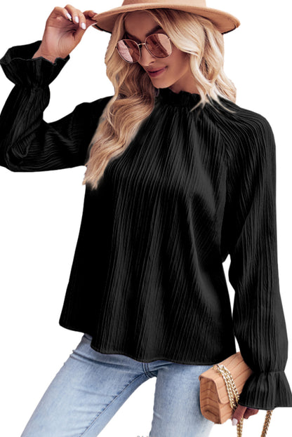 Zwarte blouse met ruches en rimpelige bubbelmouw