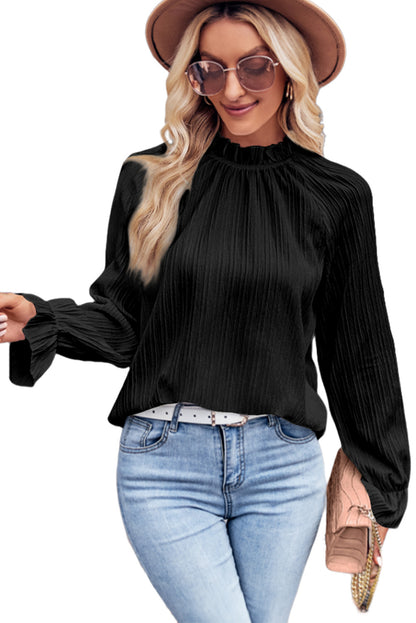 Zwarte blouse met ruches en rimpelige bubbelmouw