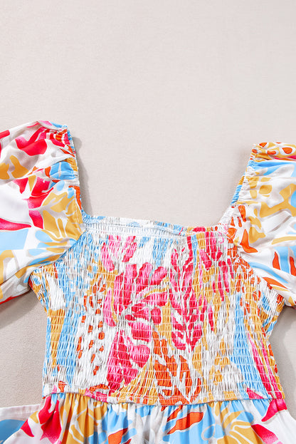 Rozerode maxi-jurk met gesmokt lijfje en pofmouwen met tropische print