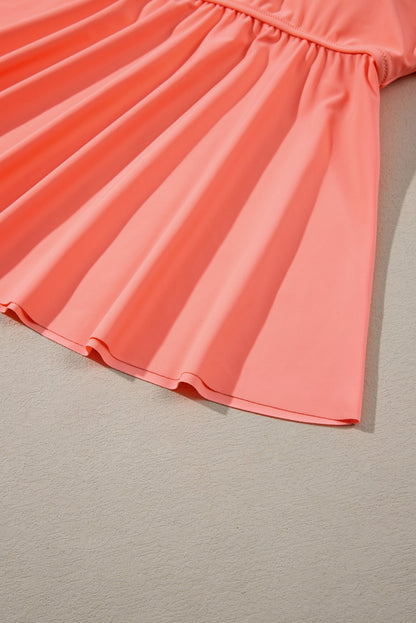 Tankini-badpak met frisse zalm en contrasterende rand met ruches en peplum-top