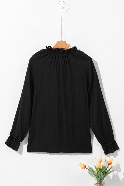 Zwarte blouse met ruches en rimpelige bubbelmouw