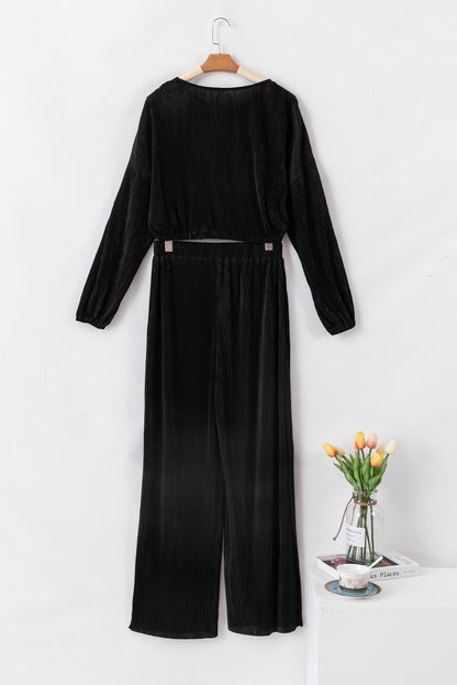 Zwarte cropped trui met koord en broek met wijde pijpen