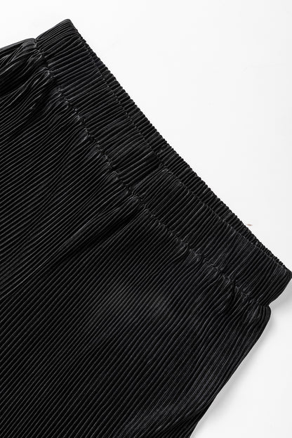 Zwarte cropped trui met koord en broek met wijde pijpen