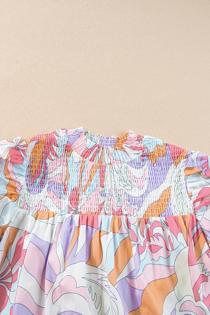 Roze blouse met abstracte print en bubbelmouwen en kieldetail