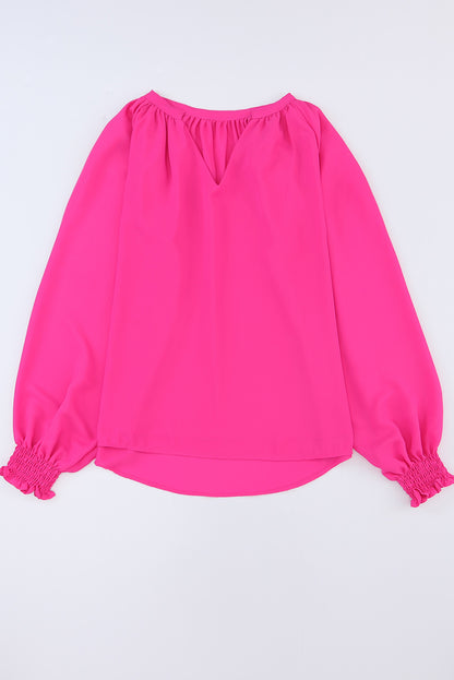 Roze geplooide blouse met V-hals en gezwollen mouwen
