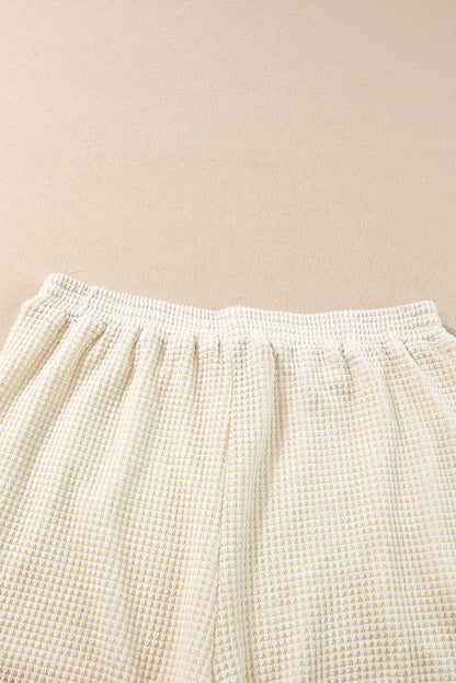 Beige korte tweedelige set met franjes en getextureerde rand