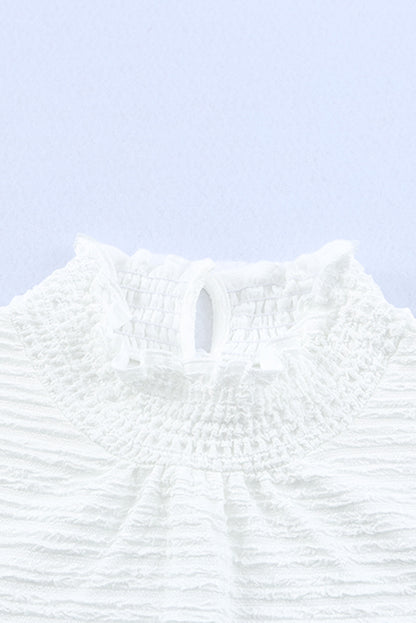 Witte blouse met gesmokte hals en bisschopsmouwen met ruches
