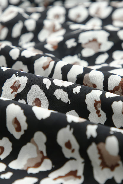 Zwarte jurk met wijde mouwen, tailleband, dubbele laag en ruches met luipaardprint met V-hals