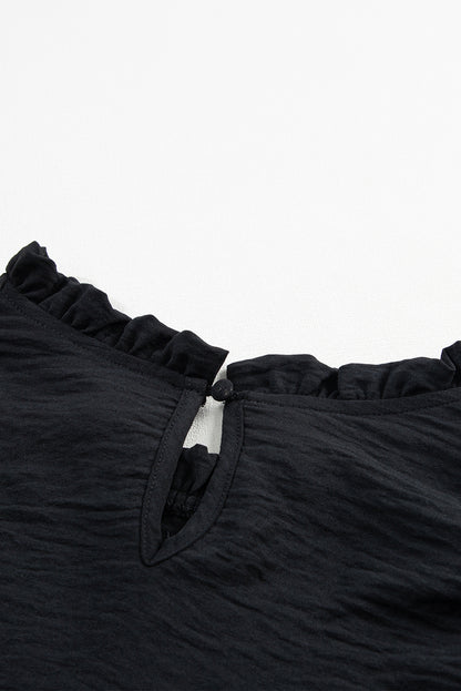 Zwarte blouse met ruches en ruches en bubbelmouwen