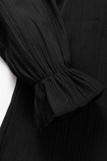 Zwarte blouse met ruches en rimpelige bubbelmouw