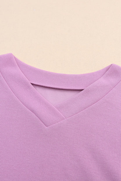 Paarse gebreide blouse met V-hals en knoopmanchetten