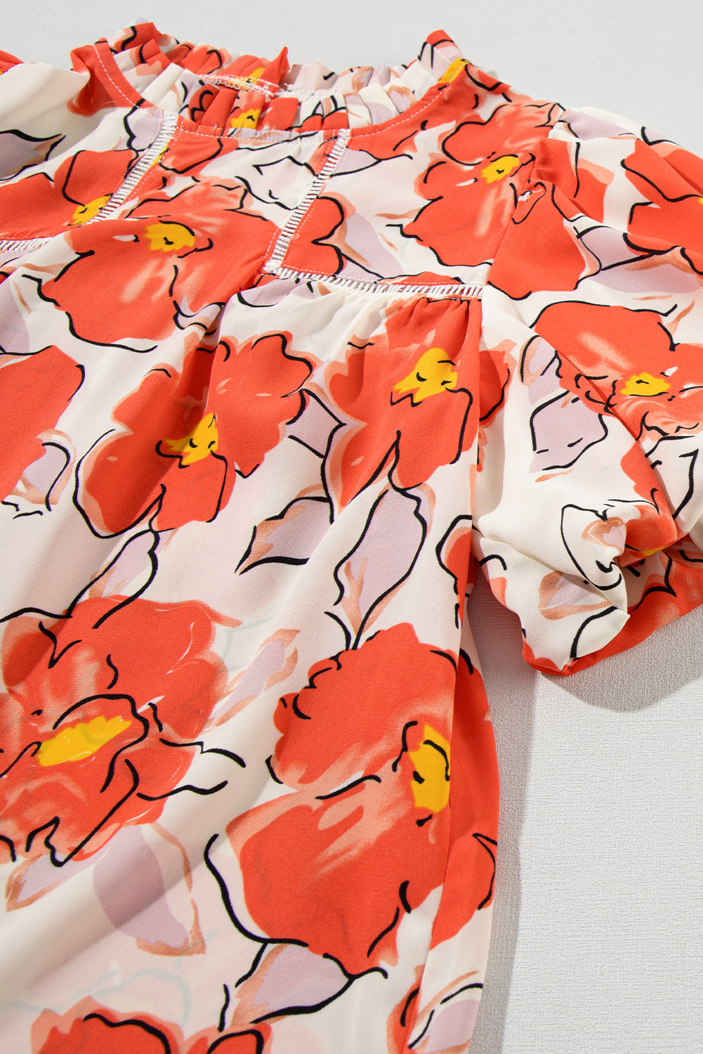 Oranje bloemen losse blouse met bubbelmouwen en ruches aan de hals